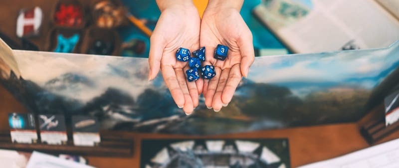 Polyhedral dice and a character sheet laid out on a game table